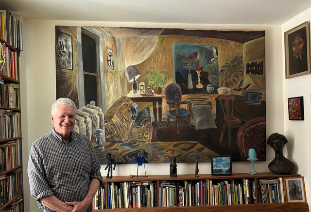 Herb in his library living room in front of one of his master works, by Rae Johnson an untitled painting of the interior of the apartment that Rae and her husband Clarke Rogers lived in on Queen Street West before moving to Flesherton, Ontario.