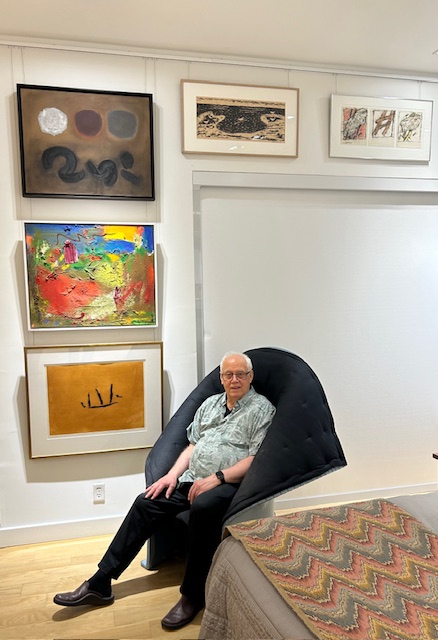 Ben Woolfitt sitting next to his bed with (from top down) Adolf Gottlieb, Hans Hofmann, Robert Motherwell, (to the right) Milton Avery and Ray Mead