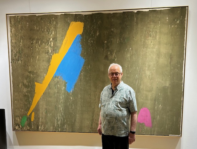 Ben Woolfitt standing in front of Jack Bush Bluegold, 1973 acrylic on canvas