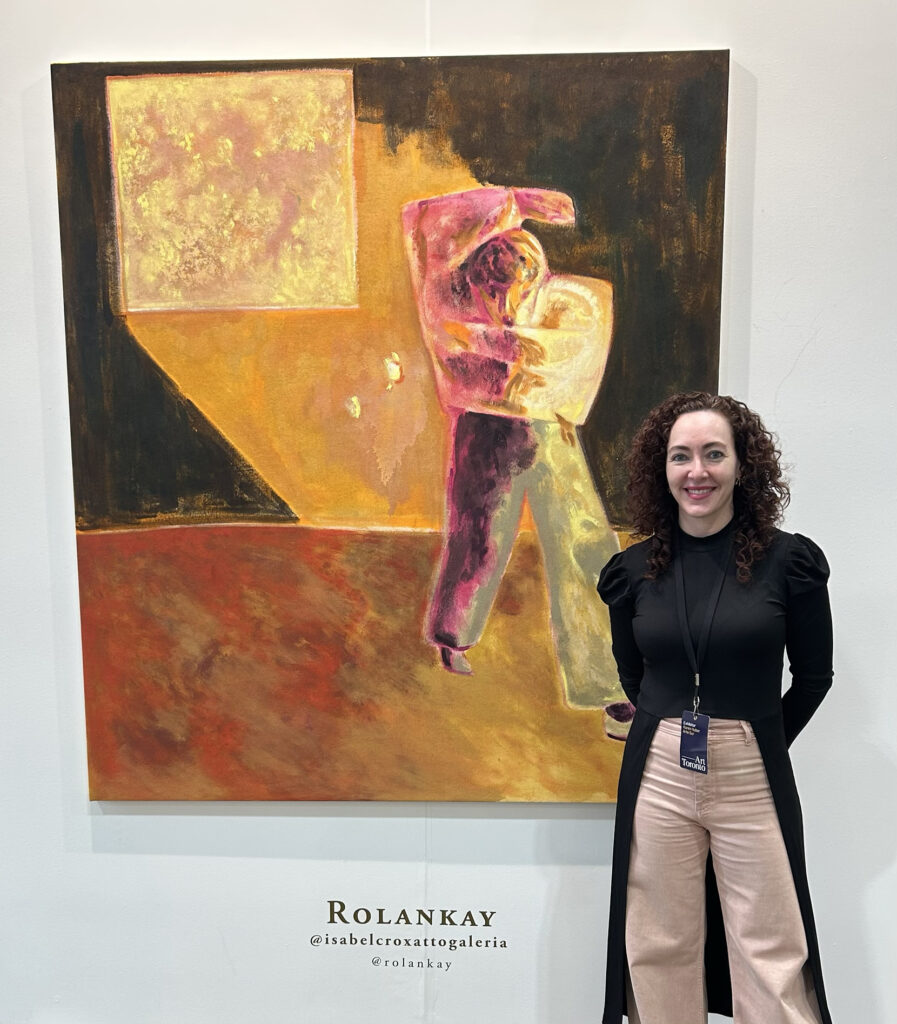 Mexican curator Karen Huber in front of art work by Chilean artist Rolankay (1989-) titled Illumination, 2025, oil on canvas 67-3/4 x 59-7/8 inches courtesy of Isabel Croxatto Galeria from Santiago, Chile