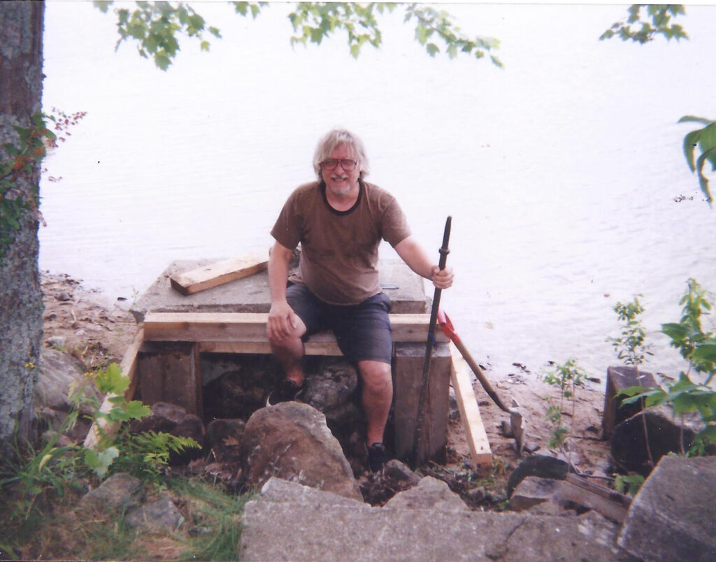 The photo was taken by Sandra MacDonald of myself with a used mining drill in my left hand at the Granary Lake shoreline September, 1995
