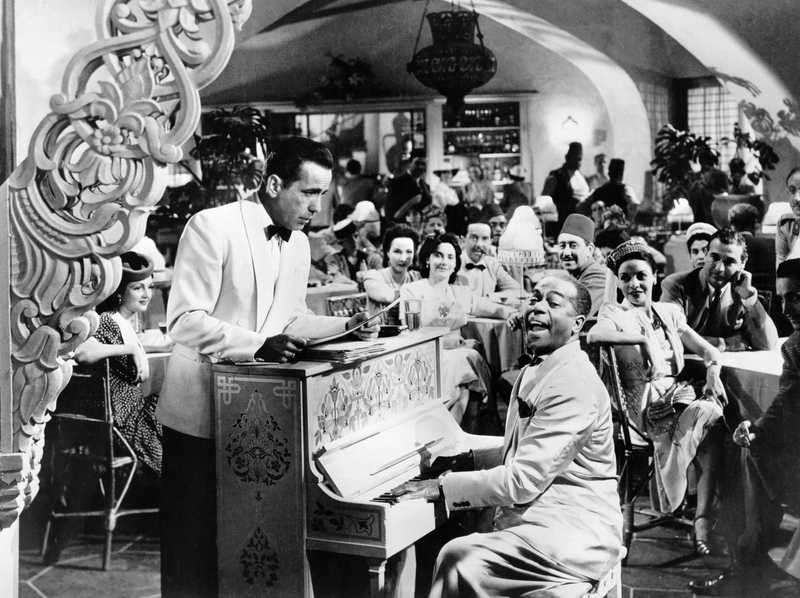 Humphrey Bogart and  Dooley Wilson, as Sam, the pianist and singer at Rick's Café Américain in Casablanca (1942). Having relatively little dialogue, Sam, nevertheless becomes one of the film's most important supporting characters