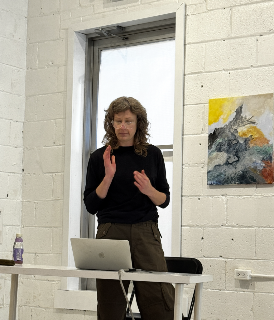 Artist Katie Pretti delivering an artist talk regarding her showcased works. The modern.toronto hosts weekend afternoon artist discussions, where the currently exhibited artist discusses their work in the presence of an audience, elaborating on their creative process, medium and more. Attendees have the opportunity to engage in an intimate setting with the artist.